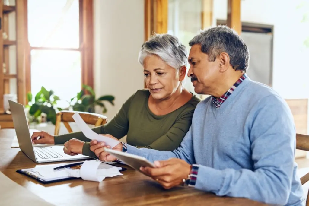 elderly couple reviewing financial papers