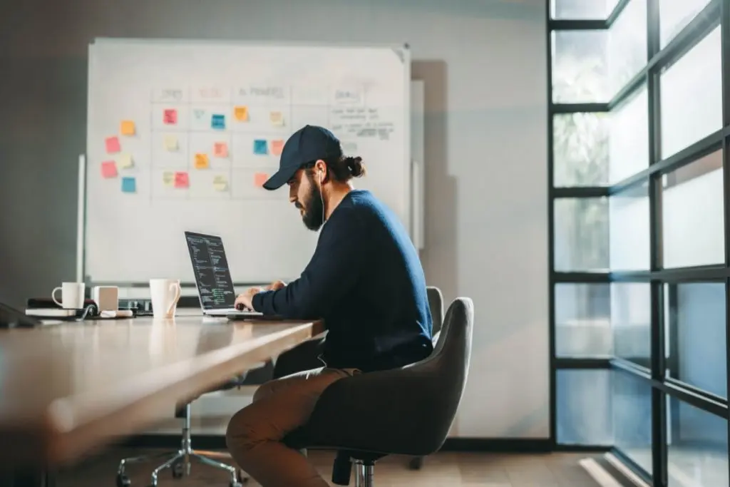 web developer writing code in a laptop