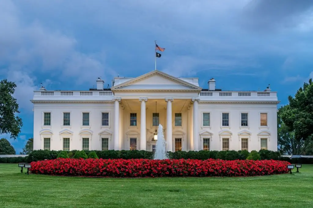 white house behind the garden and fountain