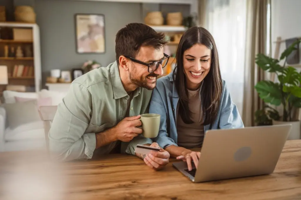 couple sorting out credit card account via laptop