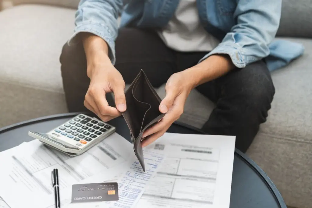 man's hands holding emply wallet looking for the ways to borrow money