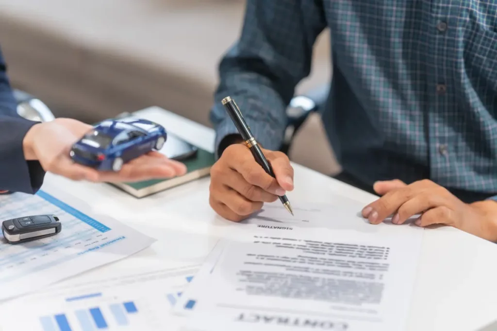 man signing loan papers