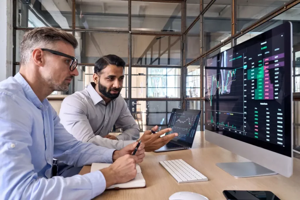 two men looking at crypto charts