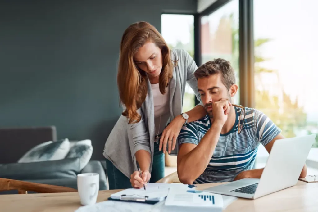 man and woman looking over bills