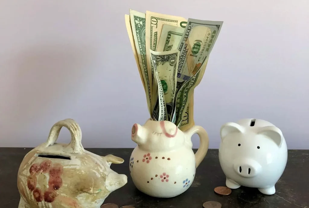 dollar banknotes in ceramic pigs