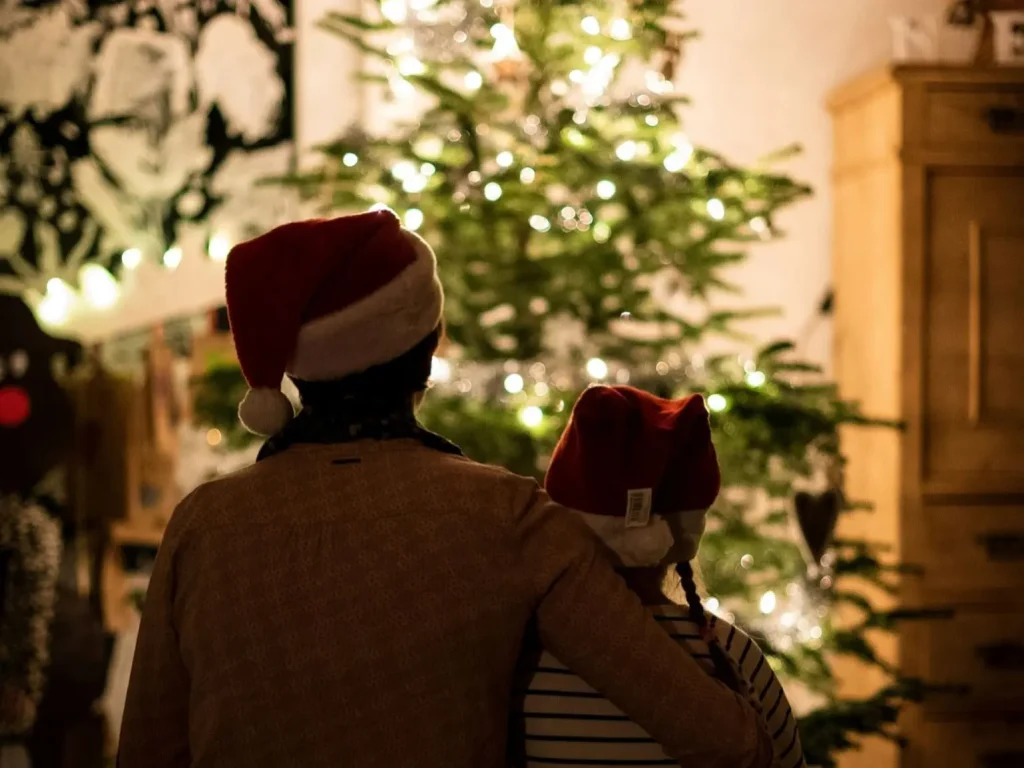 family sitting near christmas tree