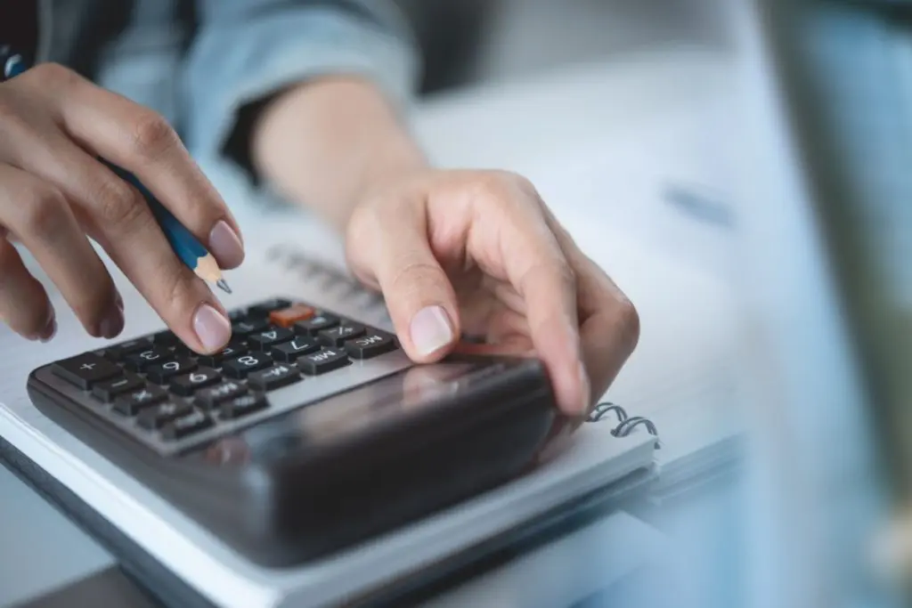 accountant hands counting taxes using calculator