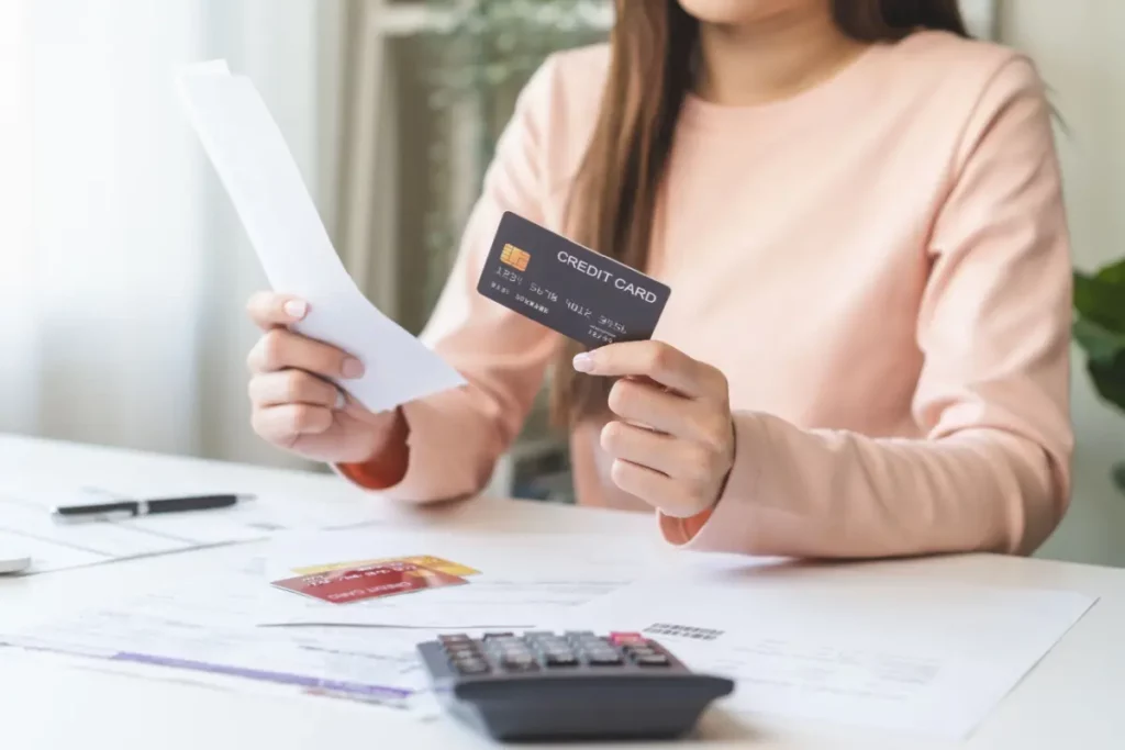 woman looking at credit card