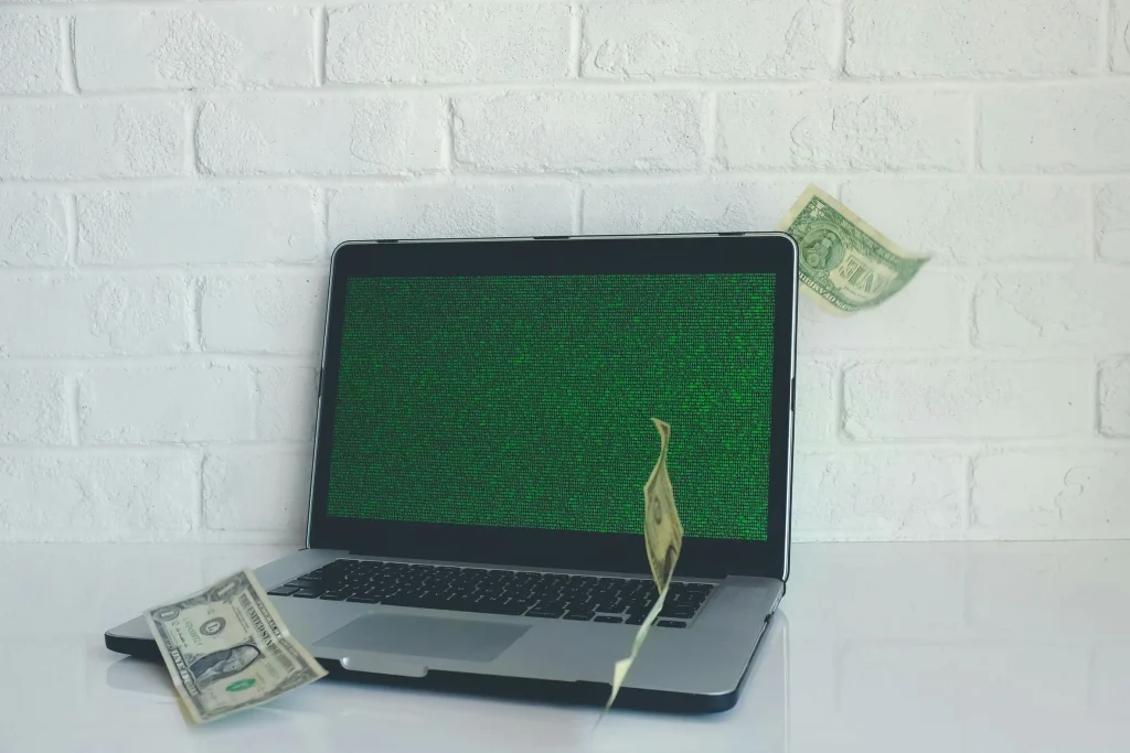 laptop with dollar banknotes