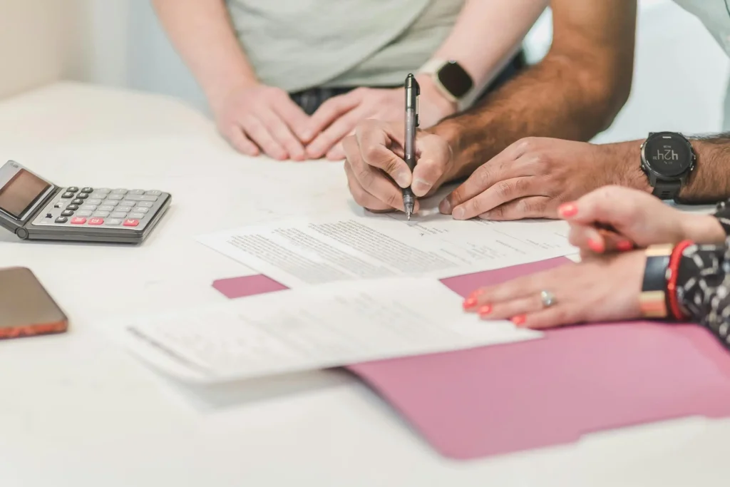 man signing paper