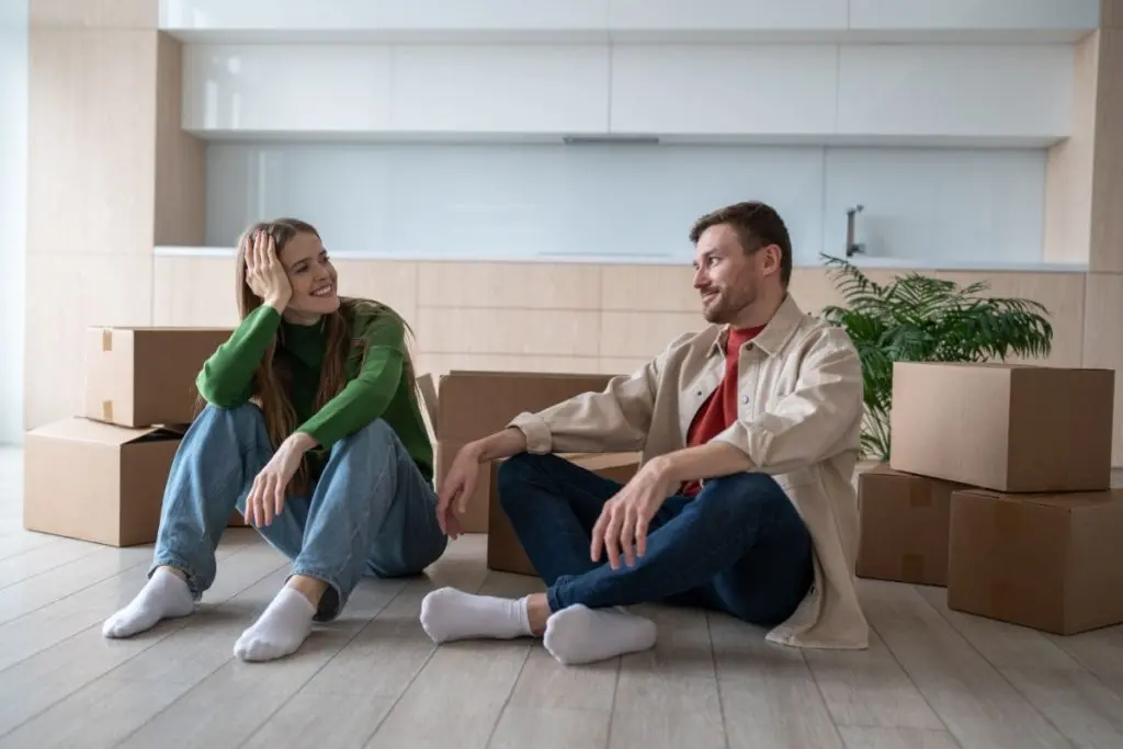 couple sitting on the floor preparing to moving out