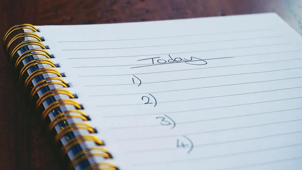 notebook with planning notes 1) 2) 3) 4)