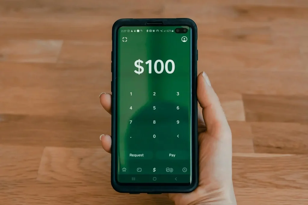 phone with opened mobile app dsiplaying $100 for cash checking