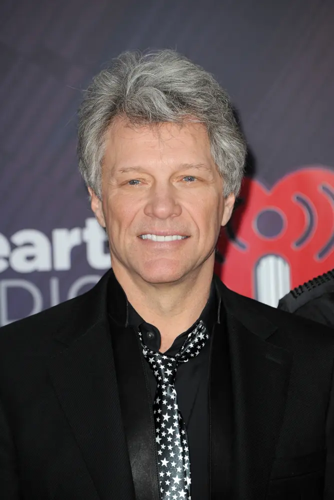 Jon Bon Jovi in a dark suit and star tie