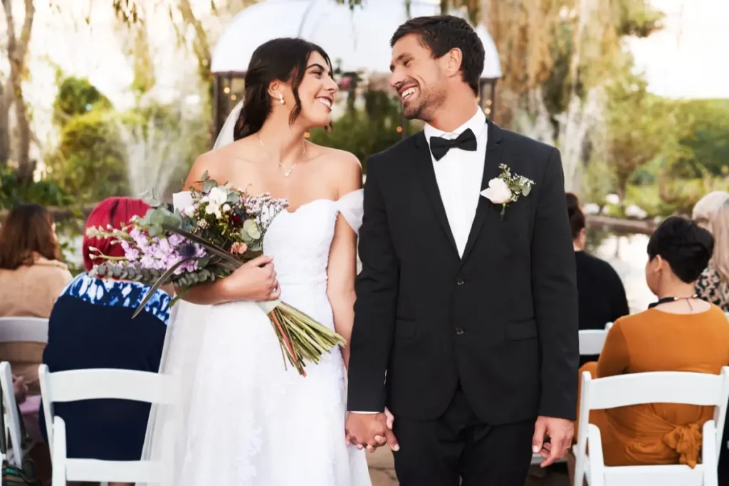 bride and groom smiling at each other