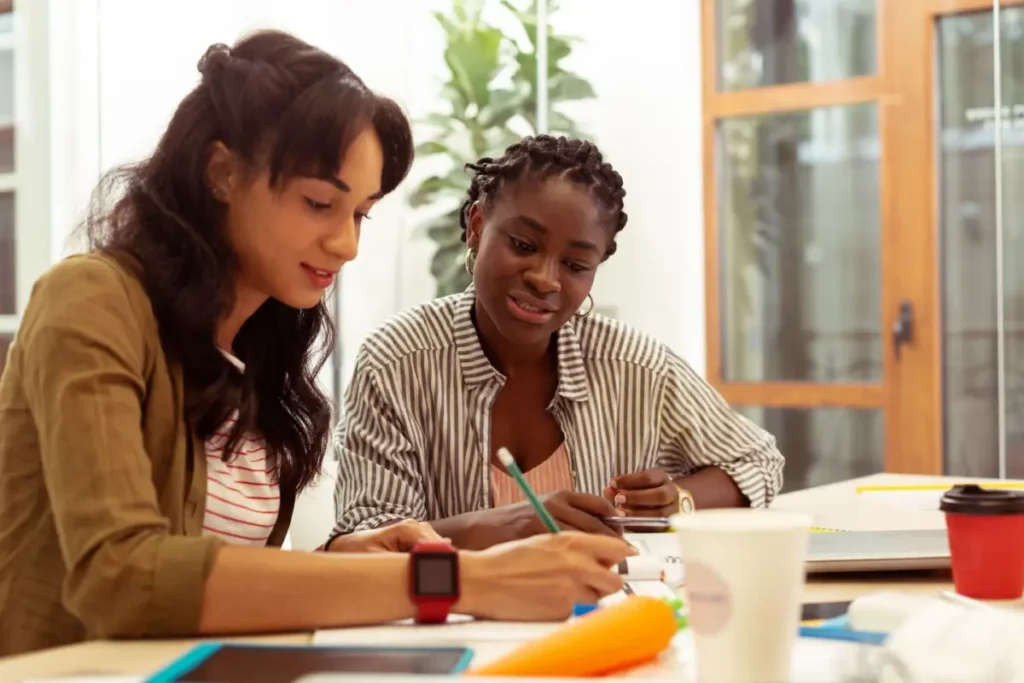 two women reading a document